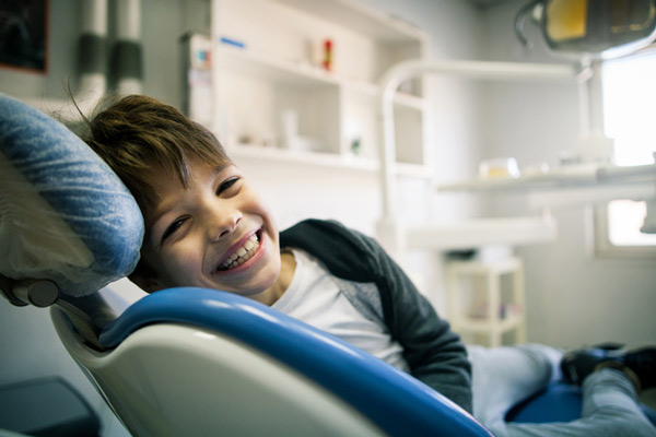 Young boy in dental chair for first orthodontic visit at Raleigh Family Orthodontics in Raleigh, NC