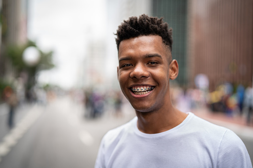 a smiling teen boy with braces