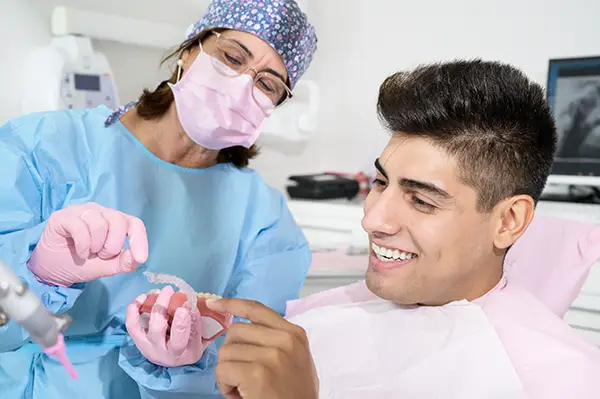 An orthodontic specialist discusses next steps with her patient, who looks excited to finish his orthodontic treatment.